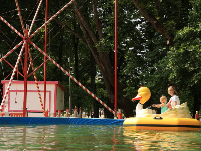 Family on swan paddle boat at an amusement park