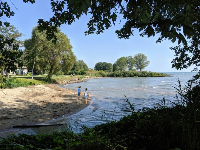 Two children walking along a Lake Erie shoreline